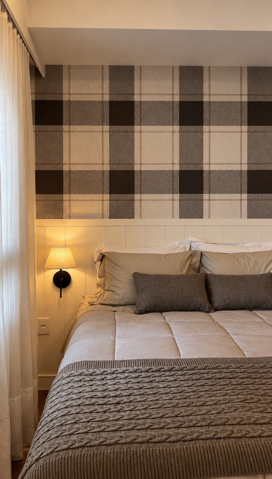 Bed with plaid wallpaper and white paneled headboard