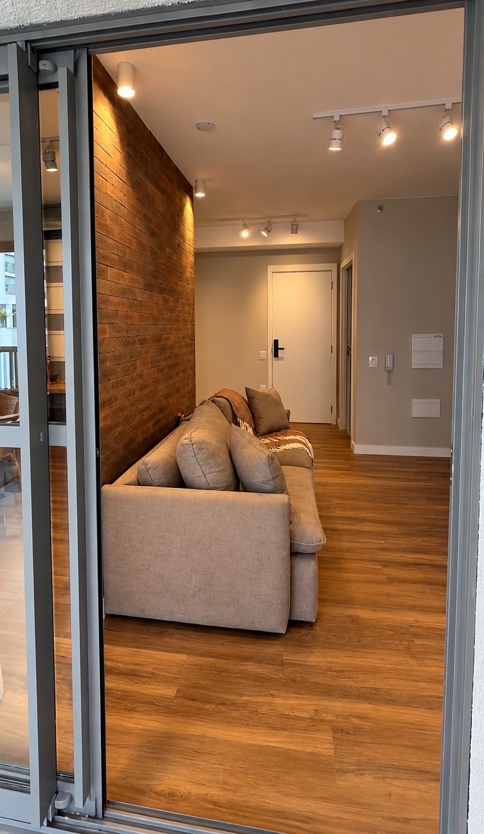 Living area with brick feature wall and sofa